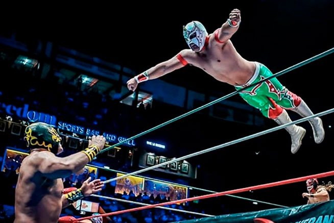 Lucha Libre exciting wrestling match and electric arena atmosphere in Mexico City