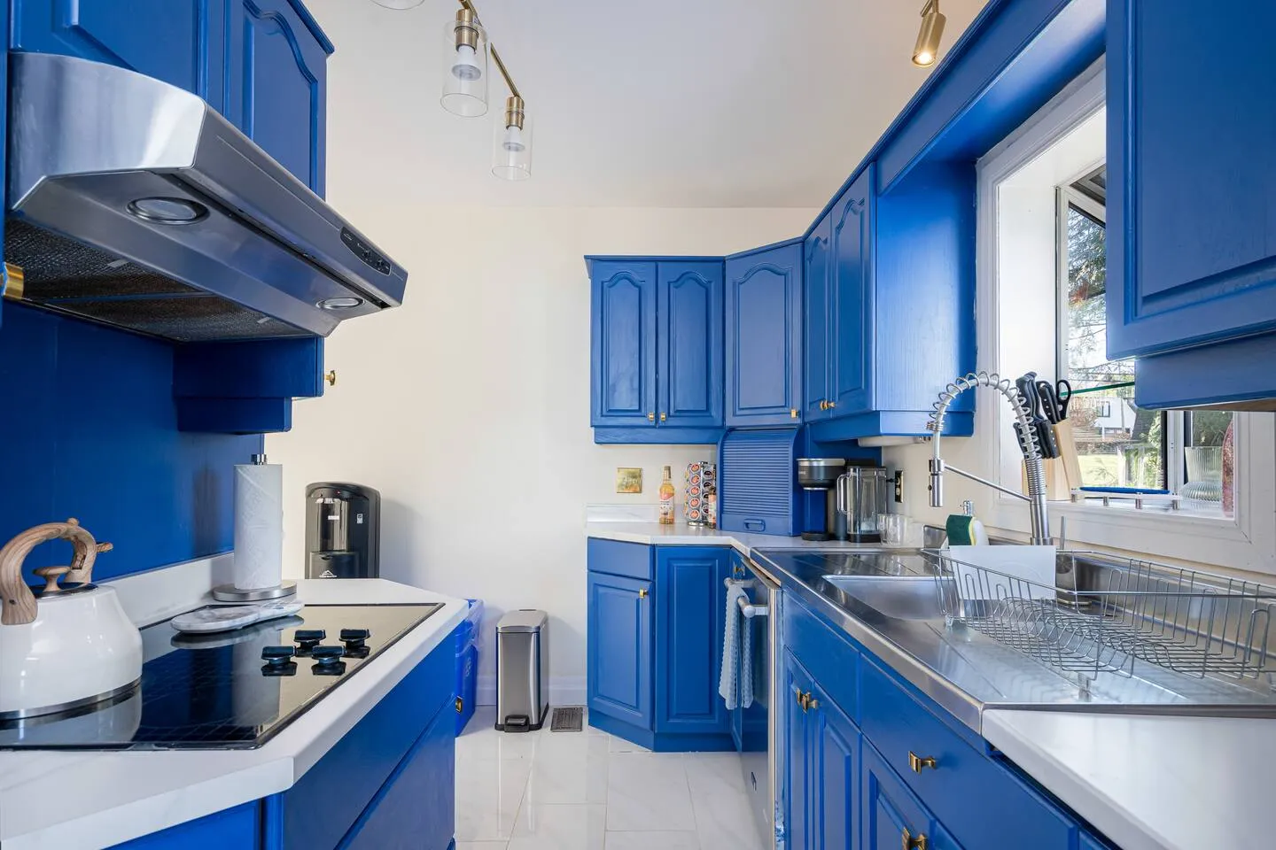 Modern kitchen with blue cabinetry at The Bluffs Bayhouse