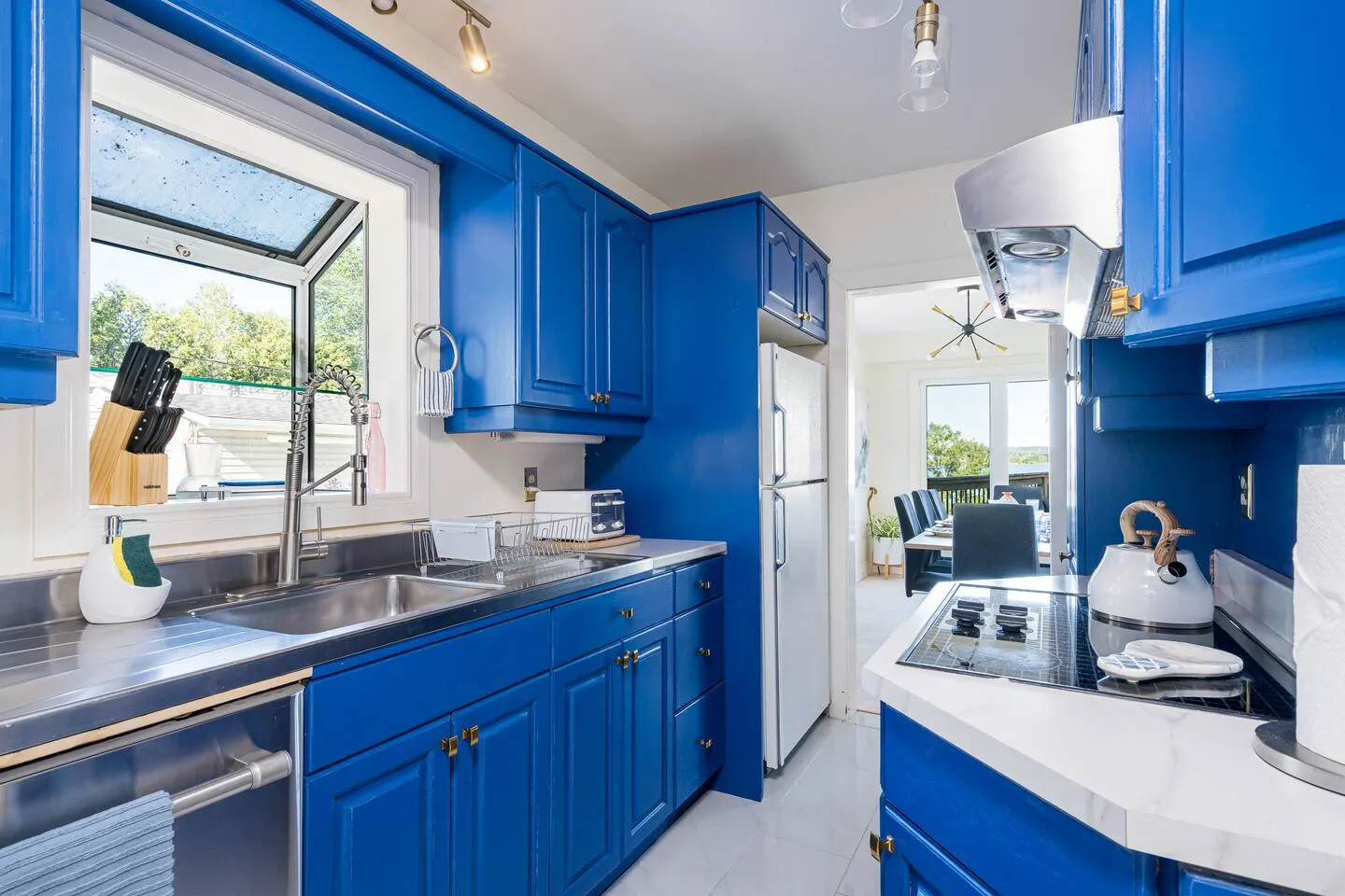 Kitchen details with blue cabinets at The Bluffs Bayhouse