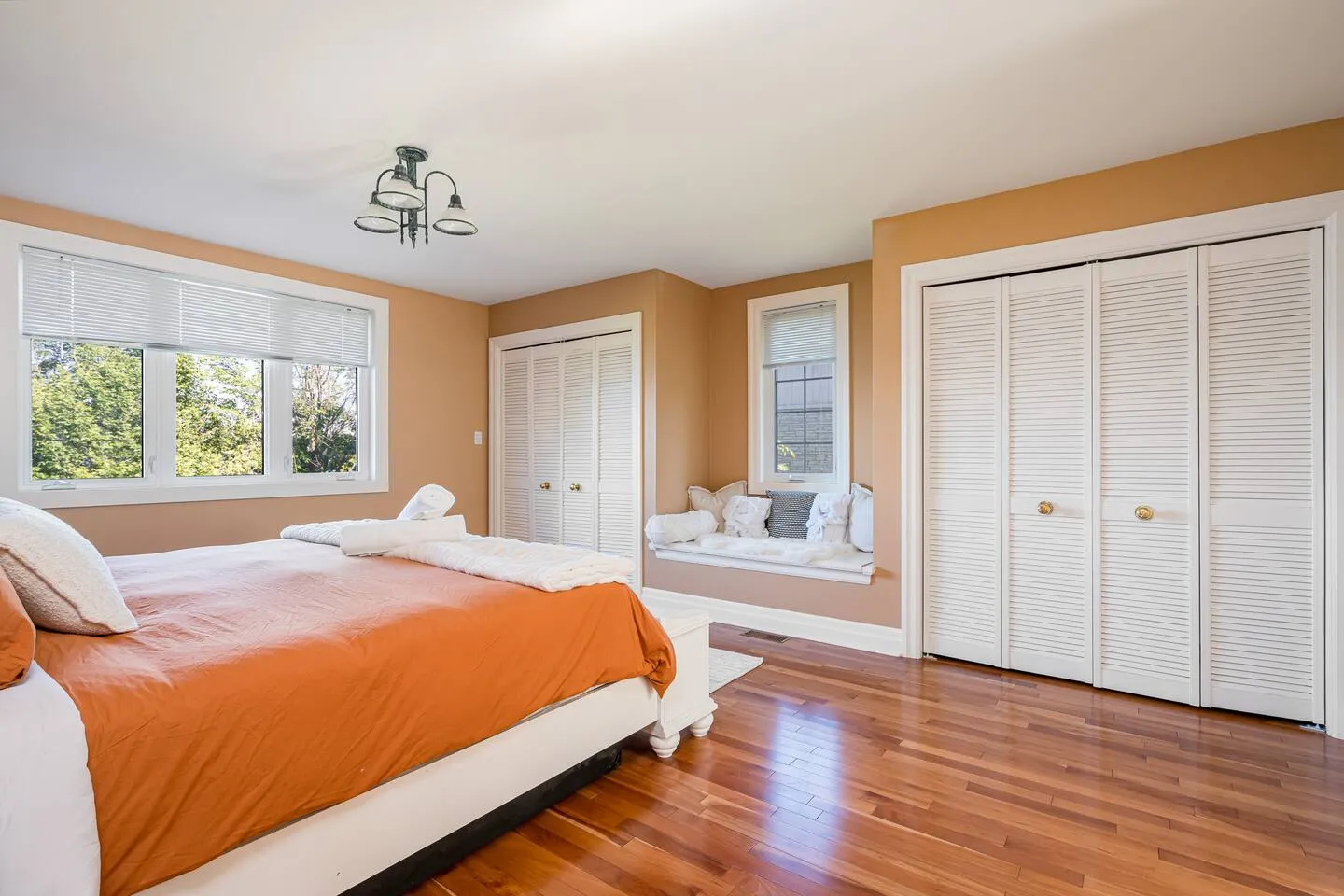 Bright bedroom with large windows at The Bluffs Bayhouse