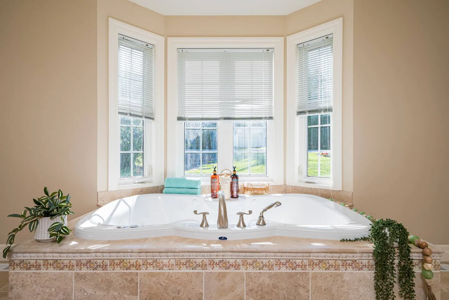 Luxurious master bathroom with soaking tub at The Bluffs Bayhouse