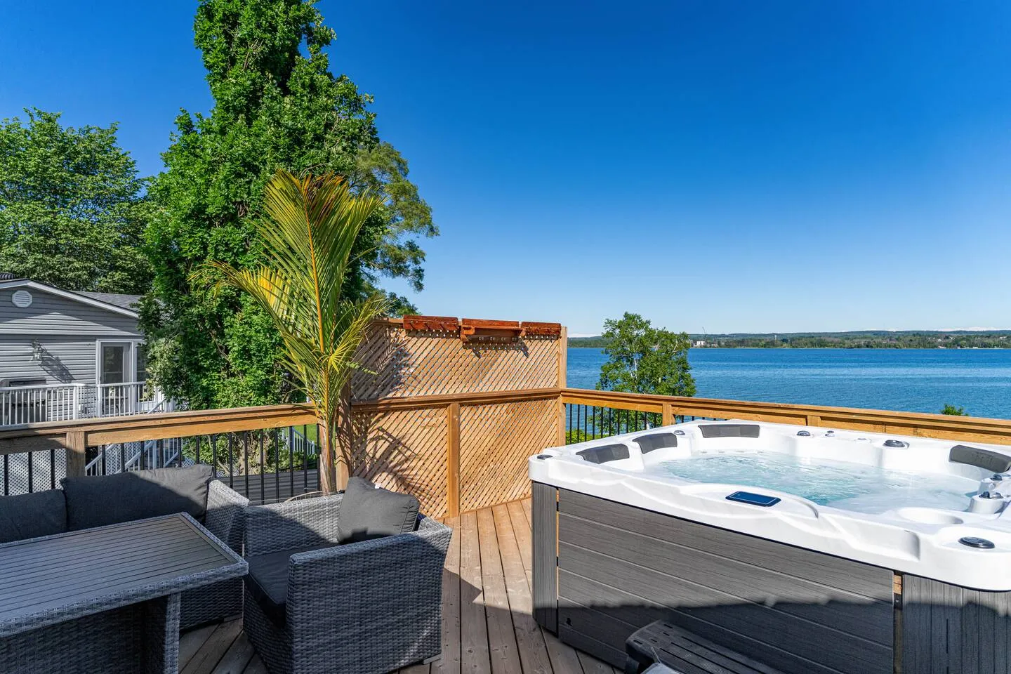 Outdoor hot tub and lake view at The Bluffs Bayhouse