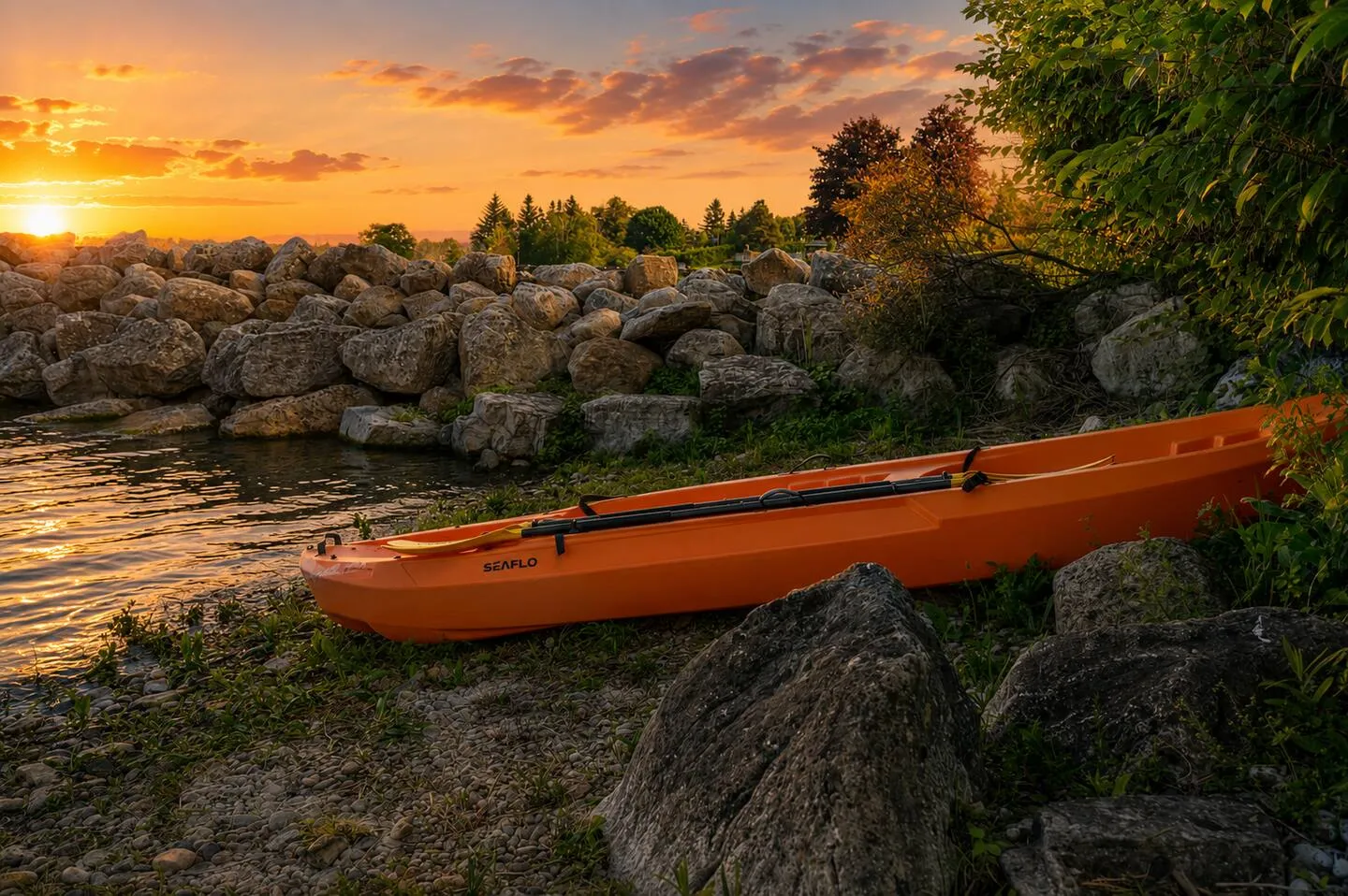 Orange kayak on the shore near The Bluffs Bayhouse