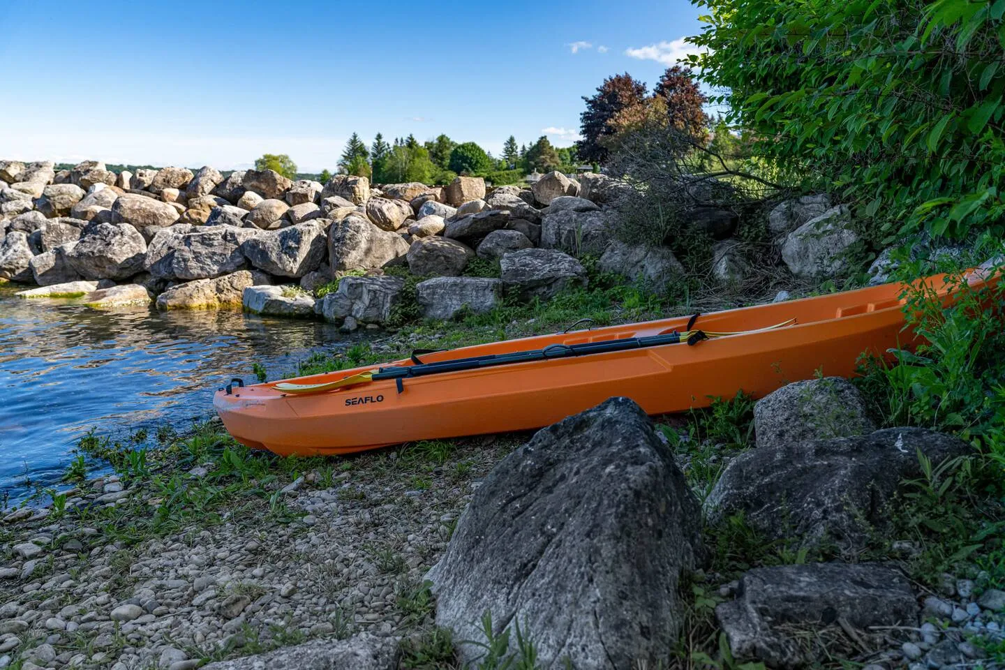 Kayak on the rocky beach near The Bluffs Bayhouse