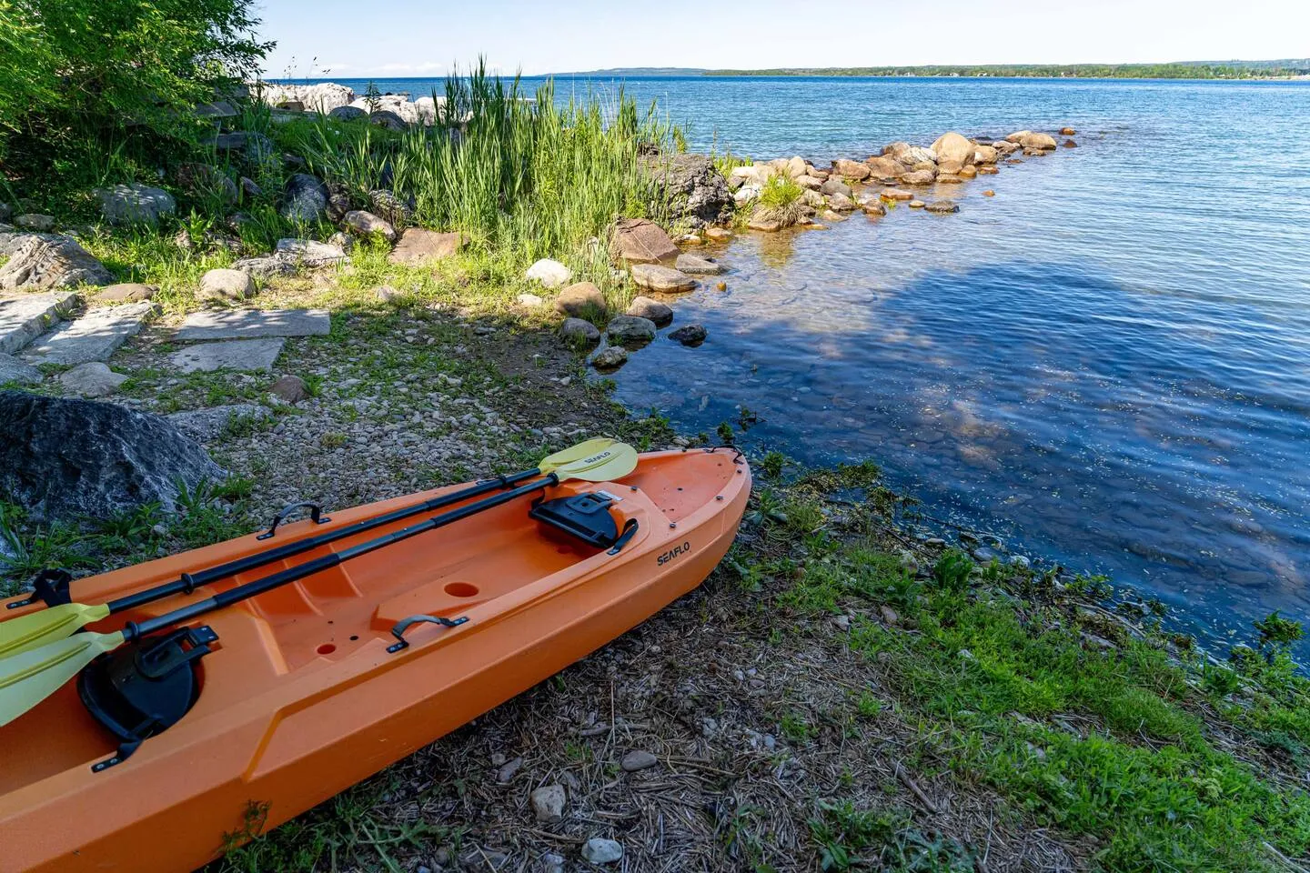 Scenic waterfront view with kayak at The Bluffs Bayhouse