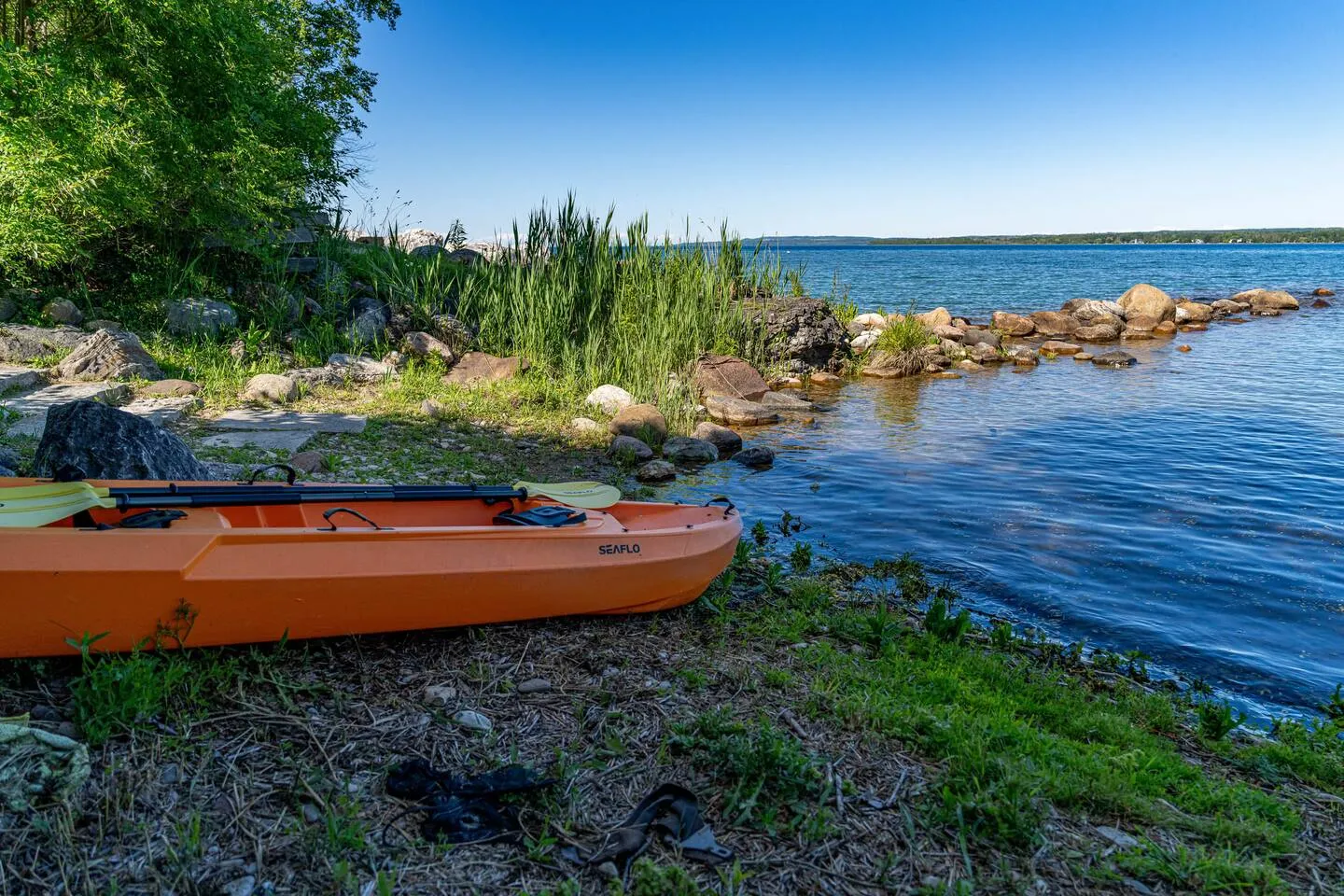 Kayak parked by the water at The Bluffs Bayhouse