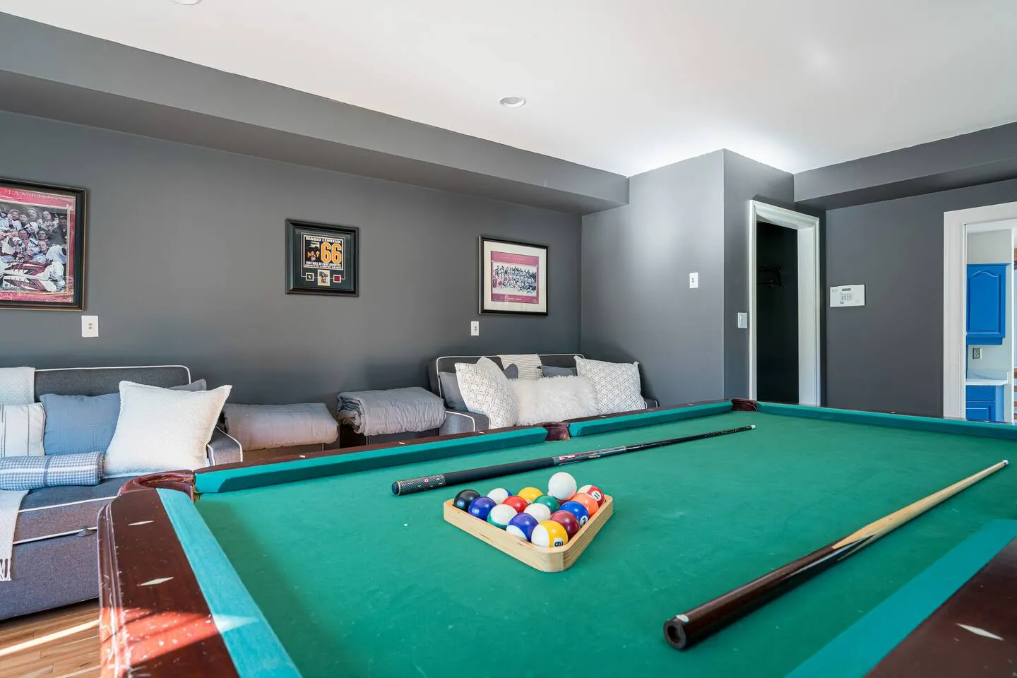 Game room with pool table and cozy seating at The Bluffs Bayhouse